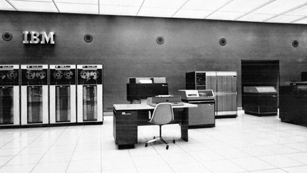 Large mainframe computer with desk and keyboard controller in foreground