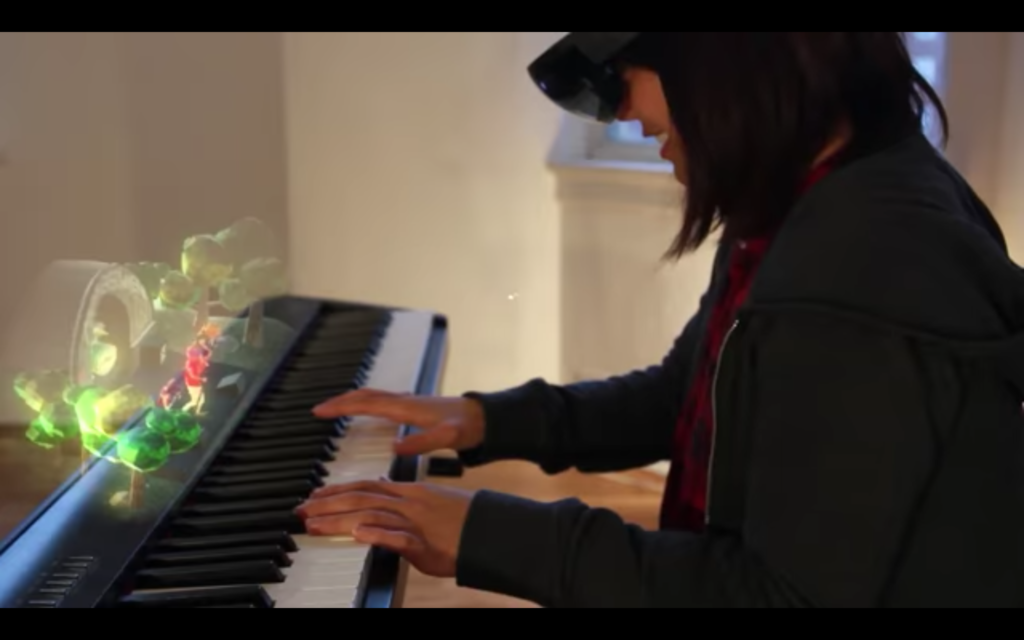 child wearing augmented reality headset playing keyboard and viewing an AR scene of animated musicians